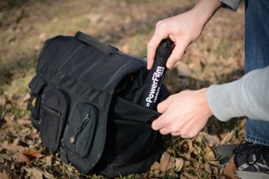 LightSaver Portable Solar Charger being put into a backpack pocket