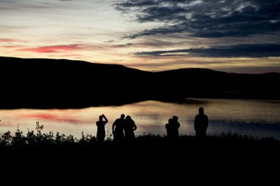 Expedition Ikivuq team by the water as the sun sets