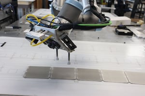 Cobot robotic arm placing a Maxeon solar cell
