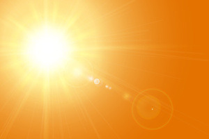 Bright, glowing sun with intense light rays spreading outward against an orange sky. Lens flares are visible, enhancing the effect of strong sunlight.