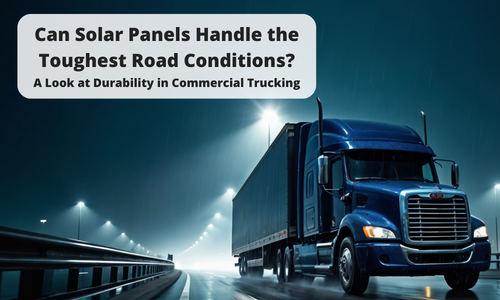 A dramatic nighttime image of a blue commercial truck driving on a misty highway under bright streetlights. The image includes a text overlay that reads "Can Solar Panels Handle the Toughest Road Conditions? A Look at Durability in Commercial Trucking."