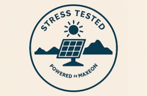 Badge with a solar panel under the sun and mountains, labeled 'Stress Tested' and 'Powered by Maxeon'.