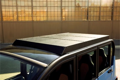 Close-up view of a blue GEM low-speed electric vehicle with a PowerFilm custom rooftop solar panel installed.