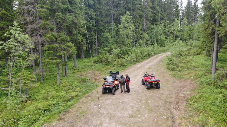 Fixed amateur radio field station supported by ATVs transporting solar equipment, batteries, antennas, and operating gear.